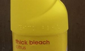 A bottle of bleach with braille signage at the top