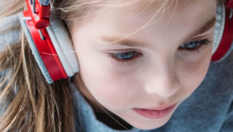 Photo of Young girl wearing headphones
