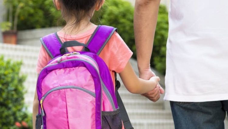 Photo of parent walking child to school