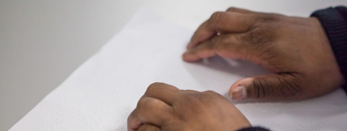 close up of hands on Braille