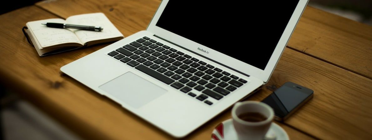 photo of laptop, coffee and notebook